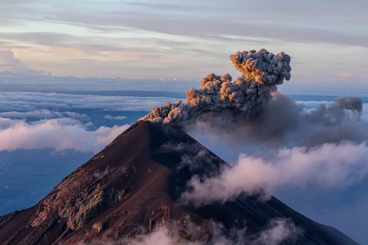 Artist illustration of a towering volcanic eruption column and ash cloud
