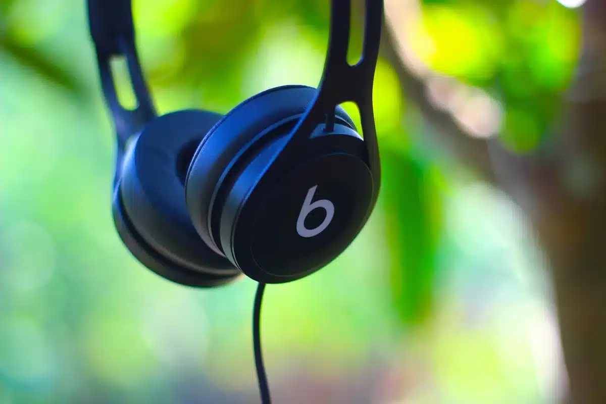 Smartphone showing a music app interface with headphones nearby
