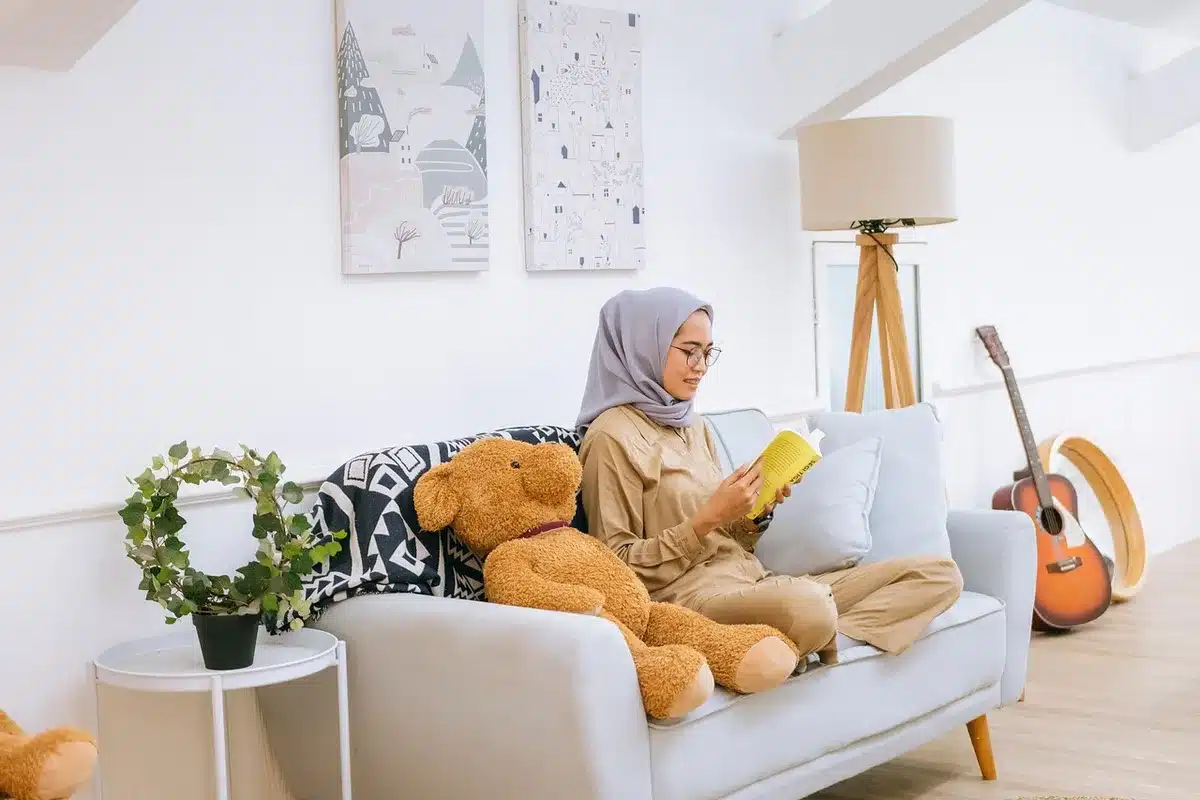 Person writing in a planner beside a smoothie and alarm clock, symbolizing routine and habits