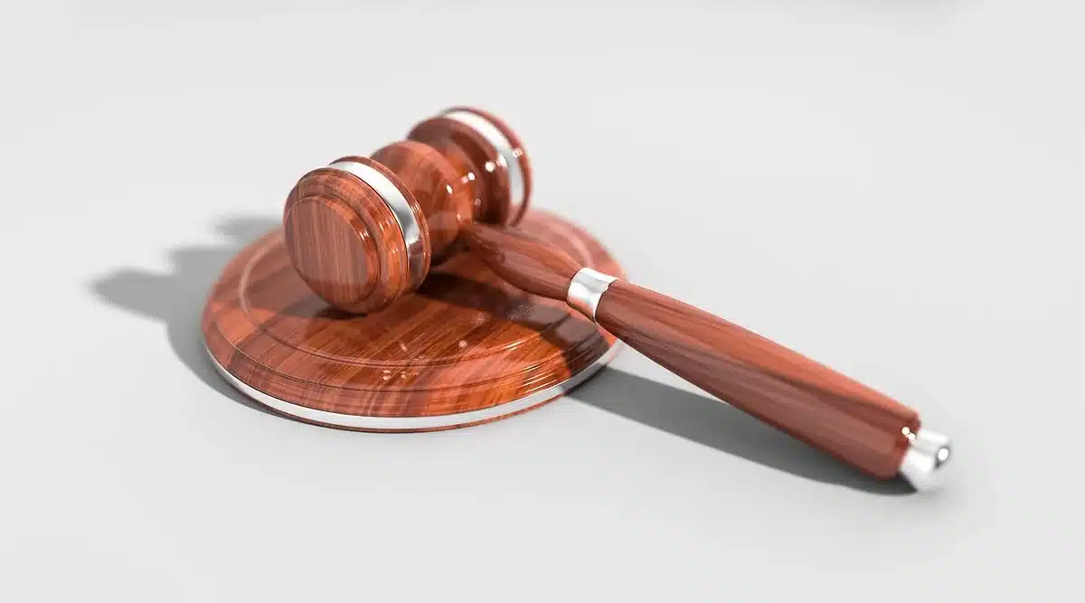 Courtroom scene with judge's gavel and legal proceedings, representing the justice system's role in mental health cases.