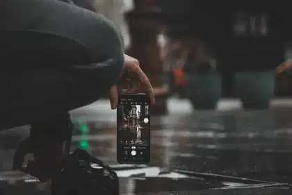 Smartphone with protruding camera module resting unsteadily on a flat surface