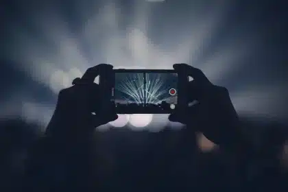 Old smartphone on a small tripod monitoring a dim hallway