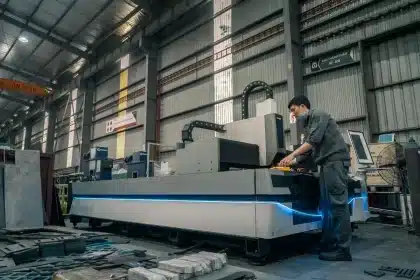 Unbranded EV bodies and robotic arms on a factory floor, representing U.S. auto production