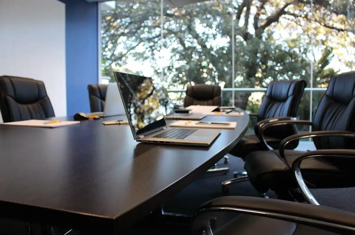 Empty corporate boardroom with negotiation documents on table