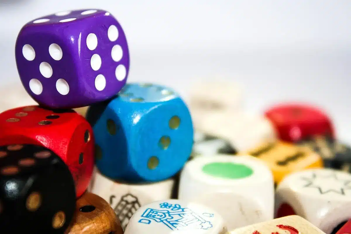 Five 60-sided dice with numbers etched on their faces, arranged to show their geometric complexity