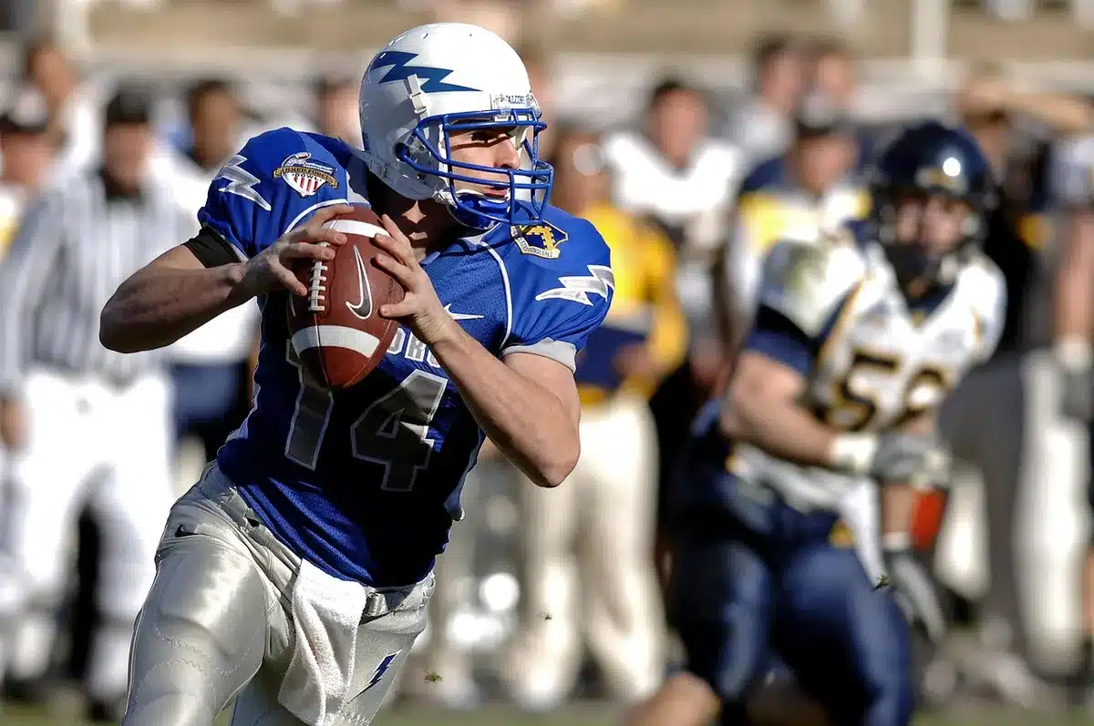 Quarterback launching a deep pass downfield toward the end zone during a crucial final-second play