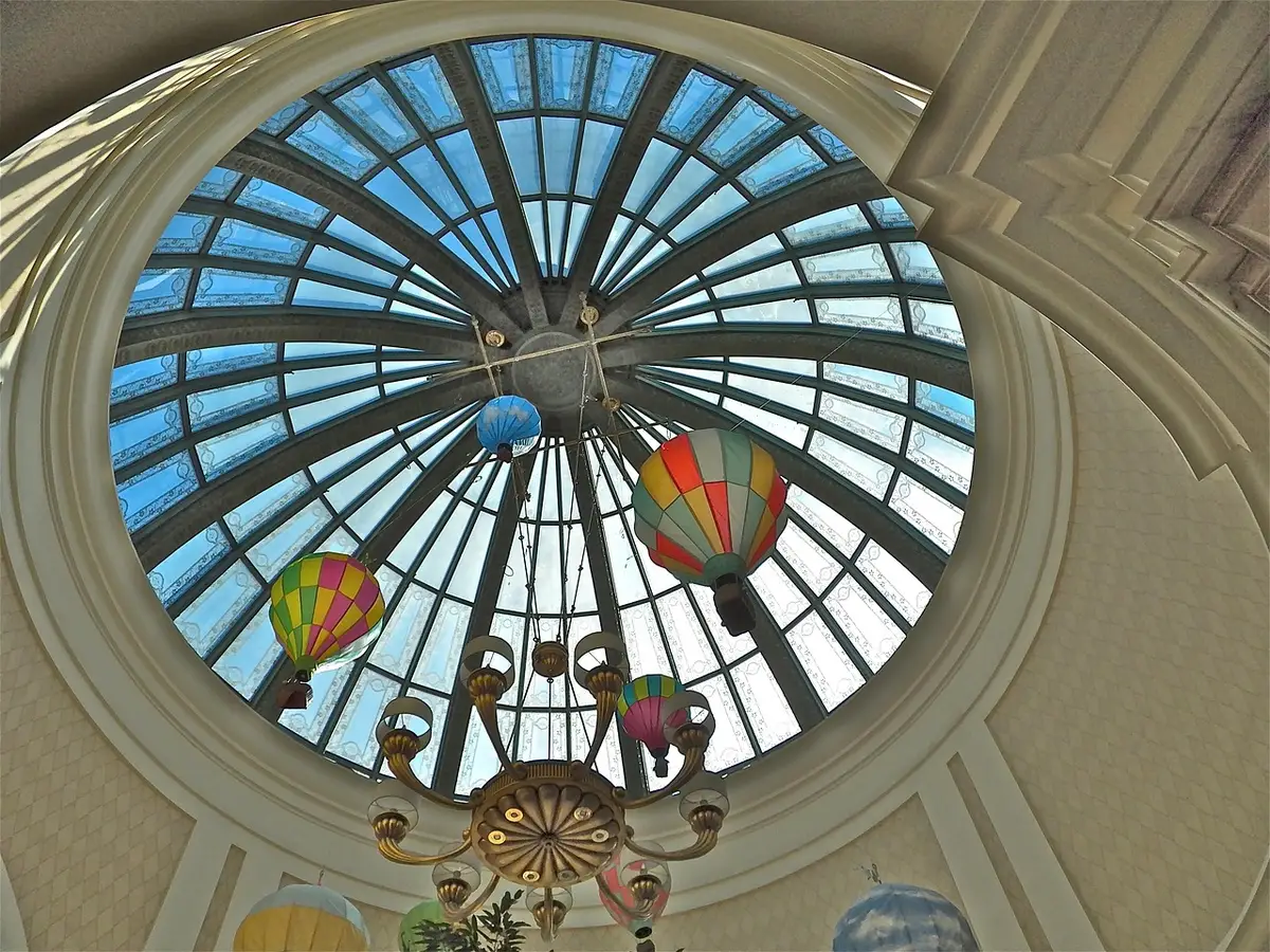 Domed vaulted ceiling pierced by arched windows inside an ancient bathing room