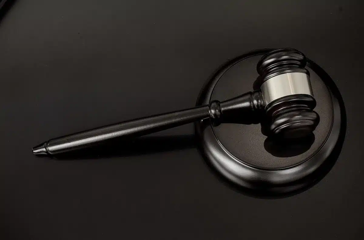 Courtroom gavel and legal documents representing merger delay