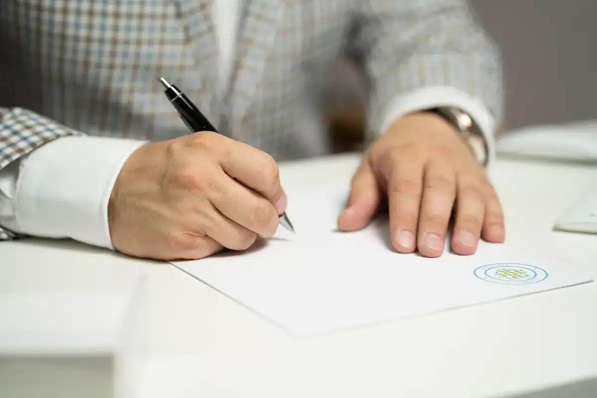Gavel beside stacked legal papers and media company reports in a courtroom context