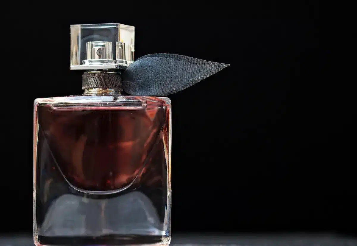 A hand blowing across a bottle opening to show a simple Helmholtz resonator