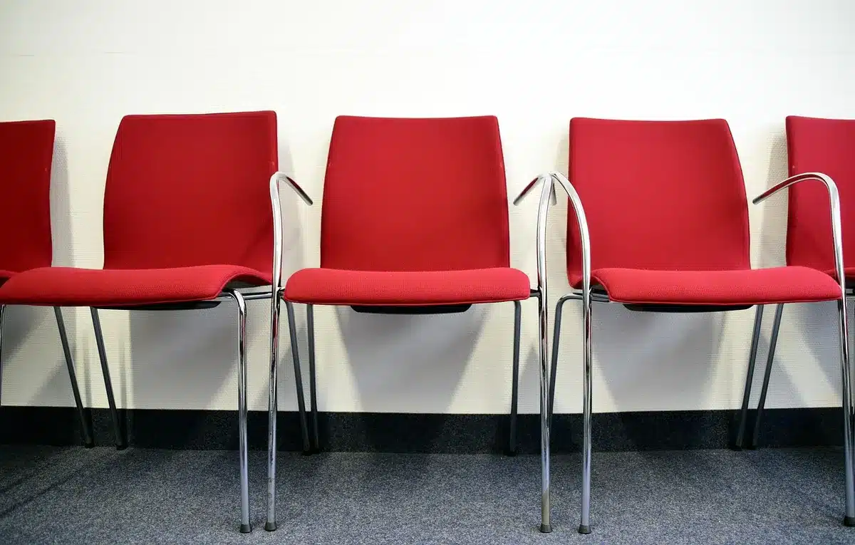 Empty chair on a TV set symbolizing a missing cast member