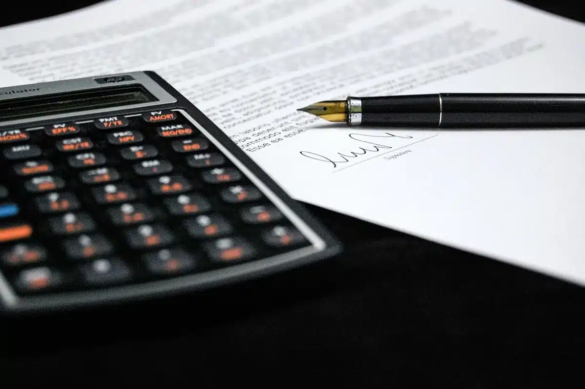 Pharmaceutical executives and government officials reviewing drug pricing agreement documents at a negotiation table