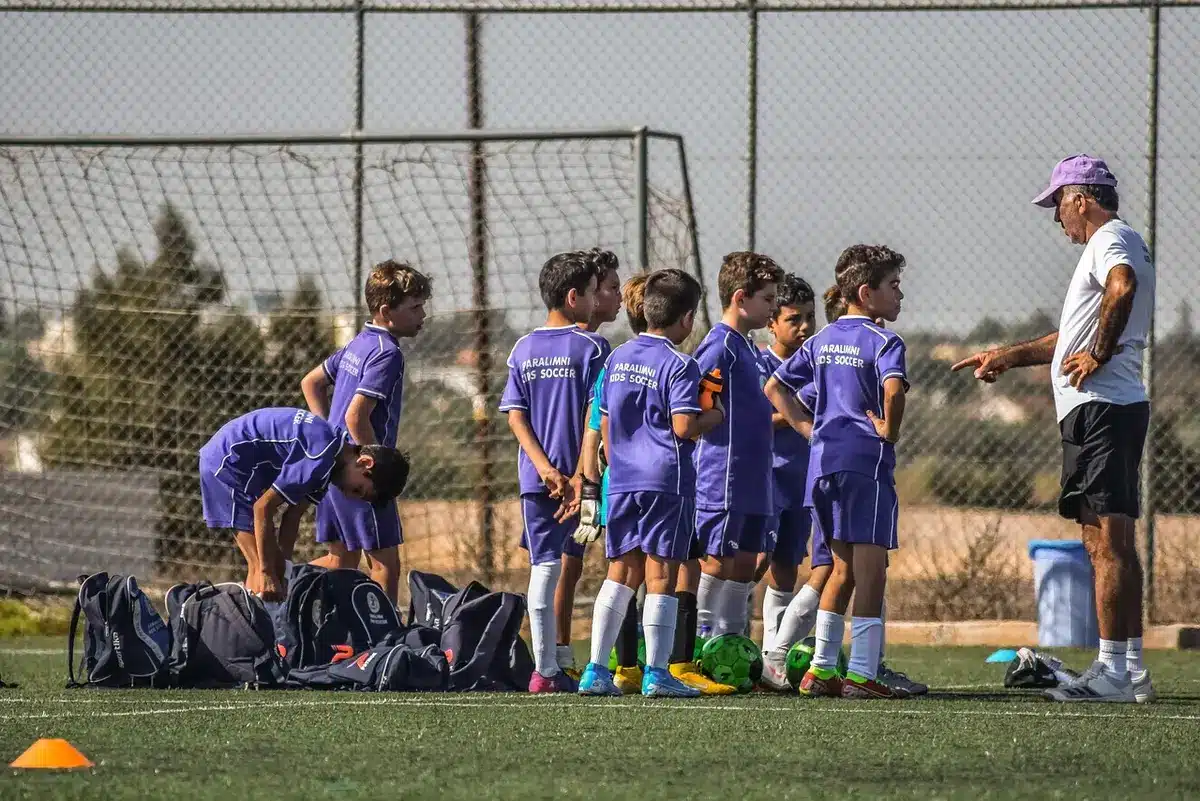 Young soccer players celebrating together on the pitch