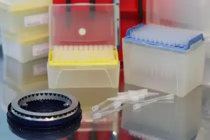 Robotic lab bench with vials and screens in a modern research facility
