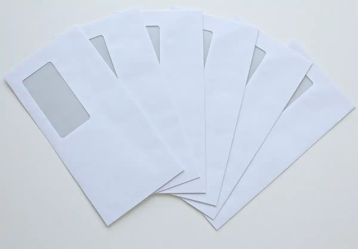 A legal cease-and-desist letter on an envelope with glasses