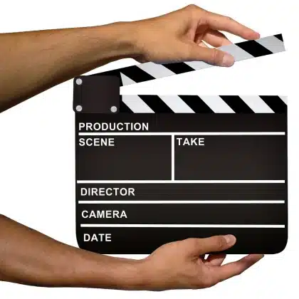 Anonymous film crew gear and clapperboard on a New York street corner