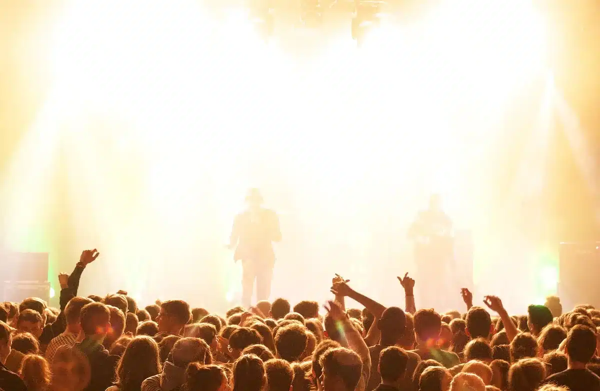 Festival headline stage with crowd at dusk