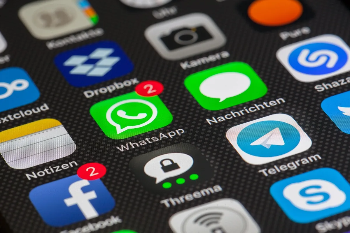 Phone screen showing social media follower counts and engagement metrics