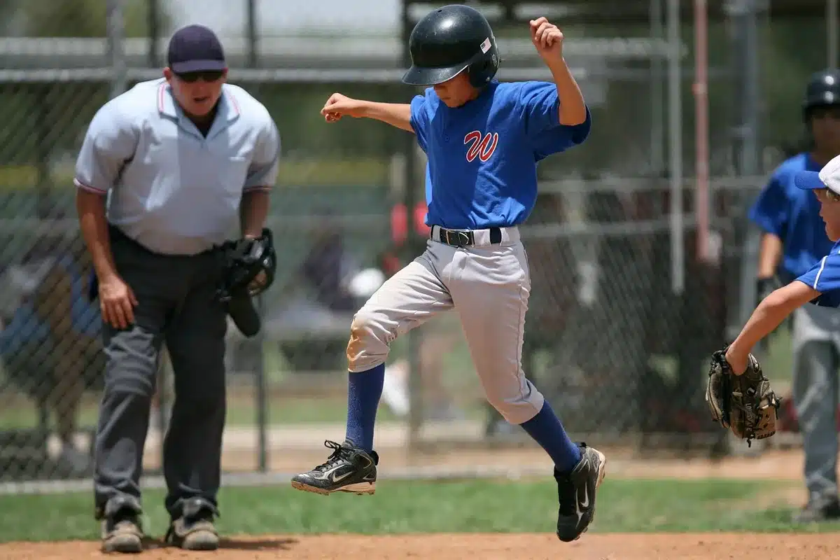 Batter following through after a powerful swing in a packed stadium