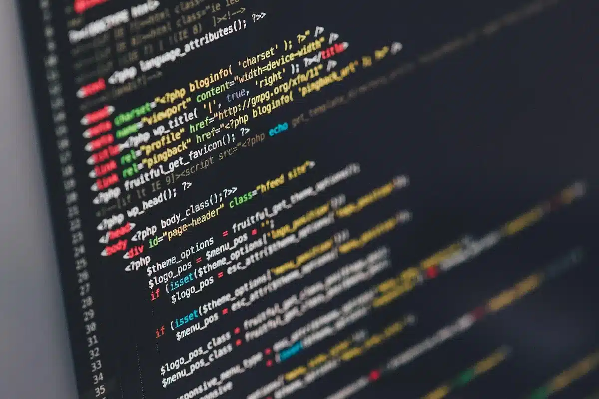 Developer optimizing a webpage for mobile performance on a laptop