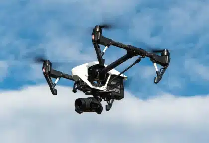 Compact gimbal and removable action camera module on a table with smartphone