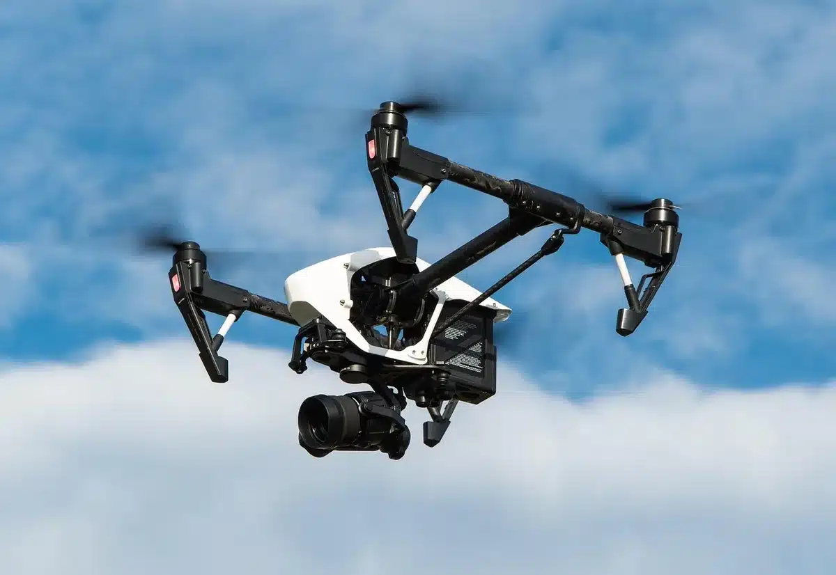 Compact gimbal and removable action camera module on a table with smartphone