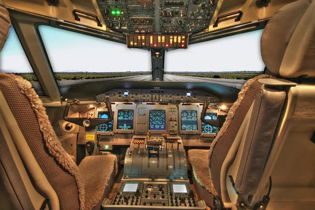 Gloved hands adjusting a generic cockpit control panel, no logos or faces