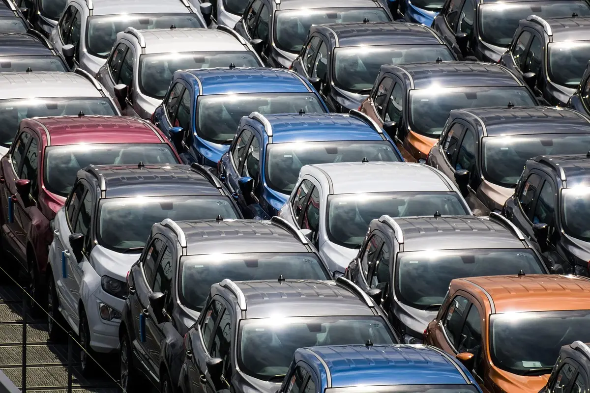 Anonymous customers viewing cars in a bright dealership showroom