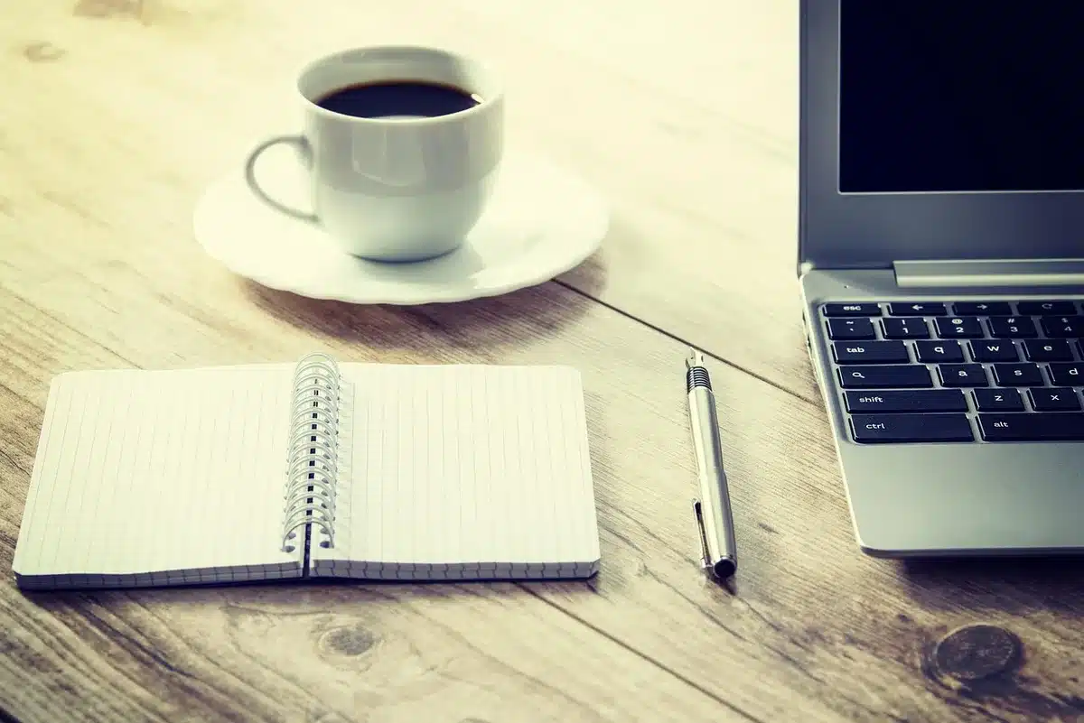 Compact handheld device docked into a small keyboard on a tidy desk