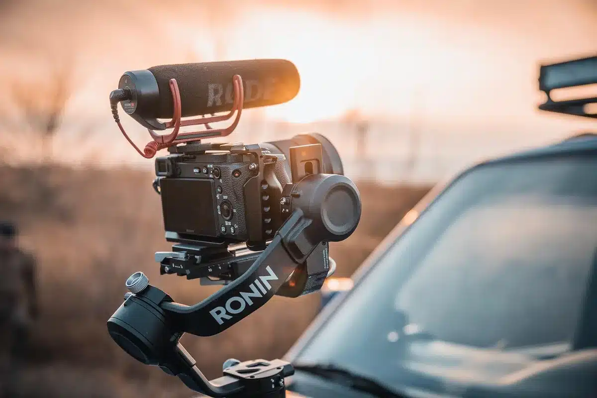 Table with a phone, action camera and gimbal to illustrate multiple devices creators carry