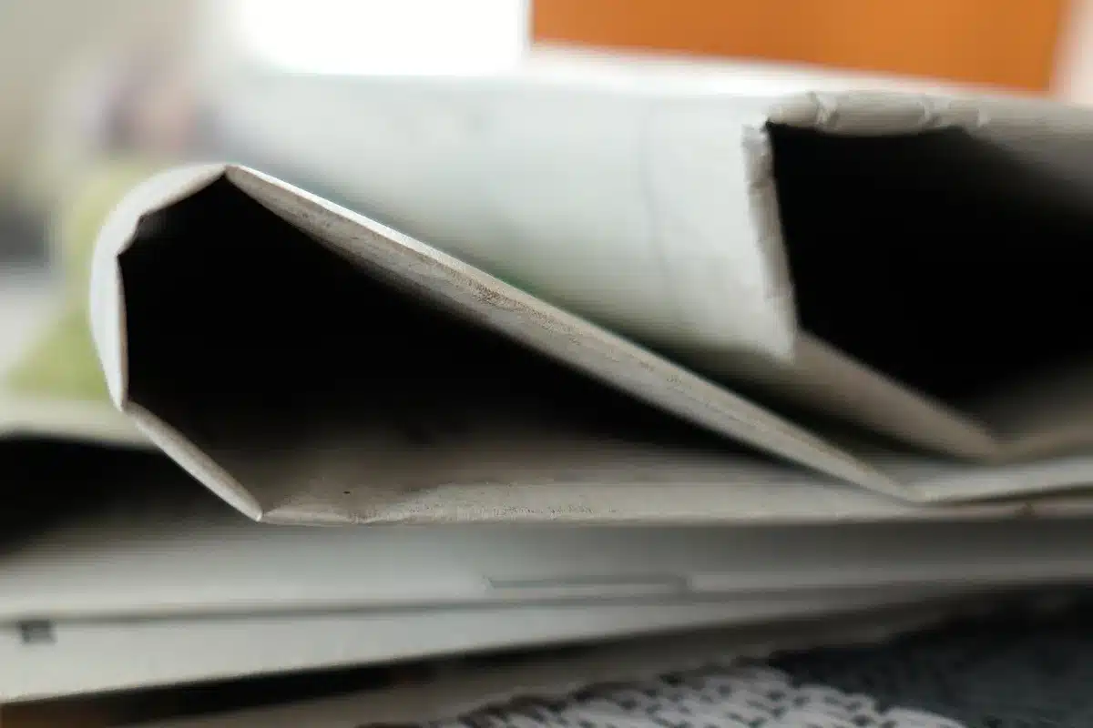 Stacks of newspapers and a newsroom desk illustrating concerns about plurality in news media