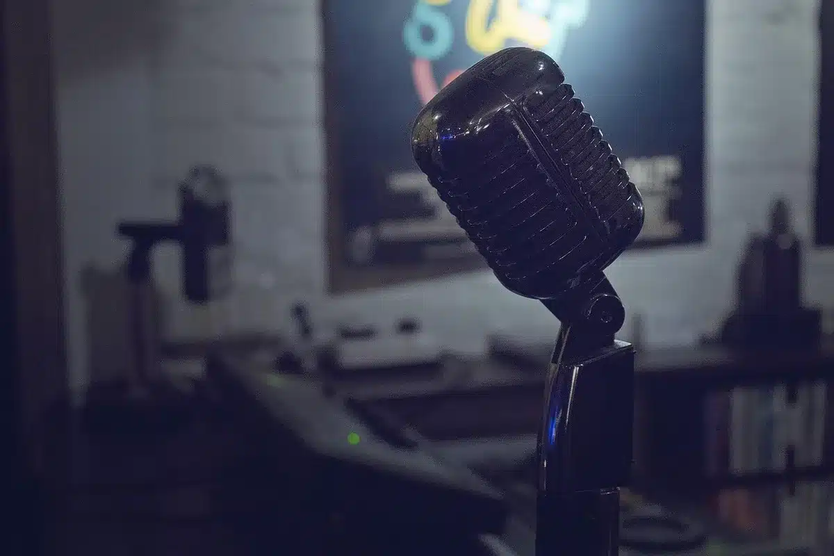 Host in a podcast studio speaking into a microphone for a true-crime show