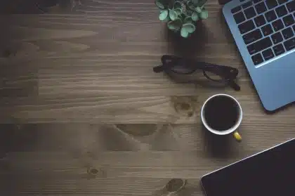 Minimalist workspace with laptop showing a simplified interface and notebook