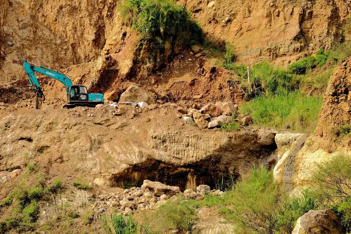 Archaeologists working at the rim of a tumulus during excavation