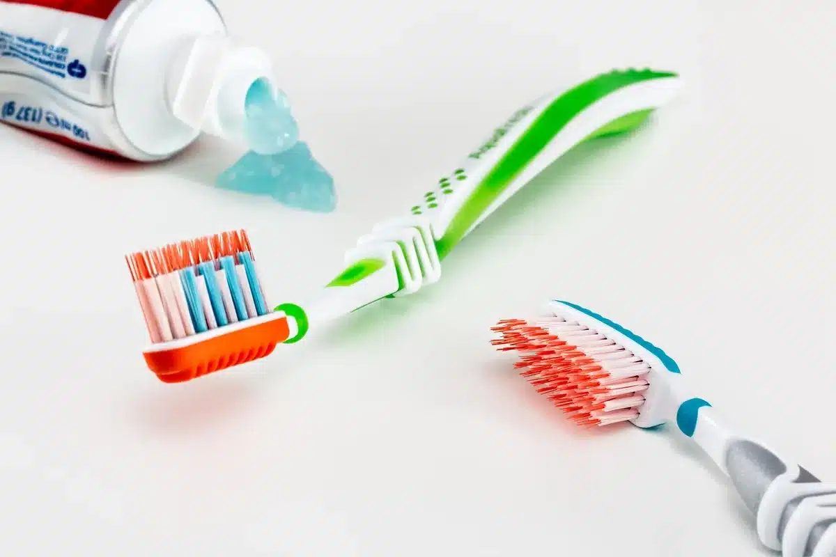 Close-up of an electric toothbrush head with a small camera module on a bathroom counter