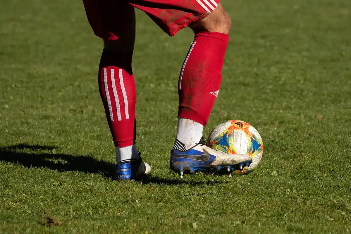 Cleats and training cones on the sideline of a community stadium before a match