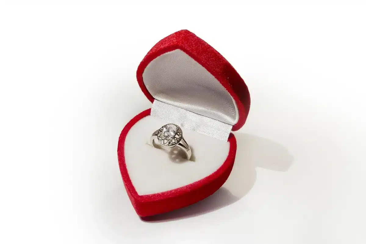 Couple embracing after a musical proposal with an engagement ring
