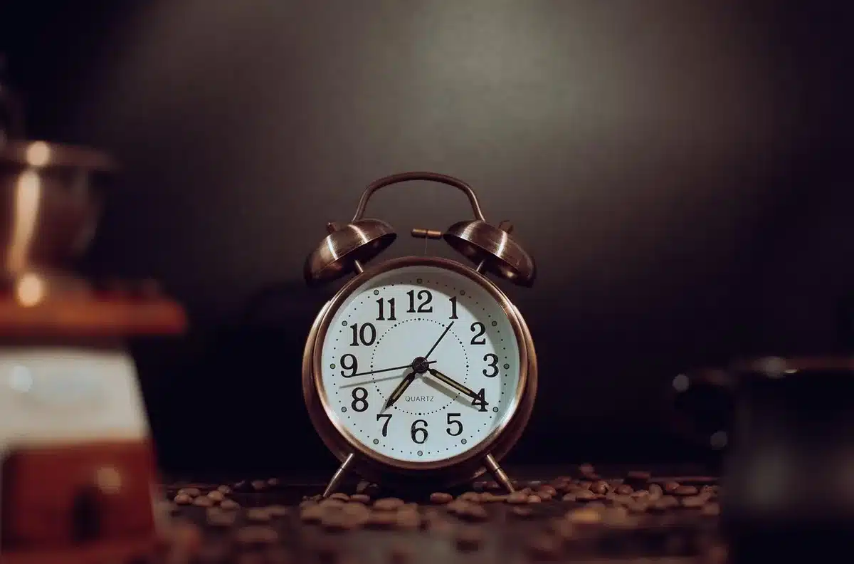 Analog wall clock with a calendar showing October and November dates